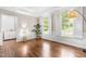 Bright living room featuring hardwood floors, white trim, large windows and designer lighting at 104 Edgewater Cir, Chapel Hill, NC 27516