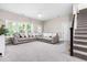 Spacious living room with neutral paint, large sectional sofa, and carpeted floor at 104 Edgewater Cir, Chapel Hill, NC 27516