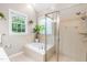 Bright bathroom featuring a garden tub, separate shower and lots of natural light at 104 Edgewater Cir, Chapel Hill, NC 27516