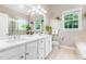 Spacious bathroom featuring double sinks, a large mirror, and neutral color palette at 104 Edgewater Cir, Chapel Hill, NC 27516