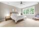 Inviting main bedroom featuring a ceiling fan and lots of natural light from multiple windows at 104 Edgewater Cir, Chapel Hill, NC 27516