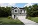 Charming two-story home showcasing stylish siding, a welcoming front door, and an attached two-car garage at 107 Vulcan St, Garner, NC 27529
