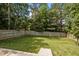 Fenced backyard with green grass and a stone paver path, perfect for outdoor activities at 109 Gladstone Dr, Durham, NC 27703