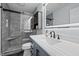 Modern bathroom featuring sleek vanity, large illuminated mirror, and tiled shower with glass door at 109 Gladstone Dr, Durham, NC 27703