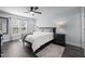 Primary bedroom featuring a ceiling fan, a large window, and hardwood floors at 109 Gladstone Dr, Durham, NC 27703