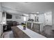 Open-concept view of dining room leading to kitchen and living room featuring dark floors and ceiling fan at 109 Gladstone Dr, Durham, NC 27703
