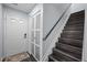 Inviting foyer featuring stairs, wood floors, storage closet, and a white front door at 109 Gladstone Dr, Durham, NC 27703
