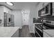 Eat-in kitchen with stainless appliances, tile backsplash, and marble countertops at 109 Gladstone Dr, Durham, NC 27703