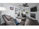 Comfortable living room features a marble fireplace, ceiling fan, dark wood floors, and an open concept at 109 Gladstone Dr, Durham, NC 27703
