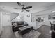 Cozy living room with dark wood floors, ceiling fan, an open concept, and view of staircase and kitchen at 109 Gladstone Dr, Durham, NC 27703