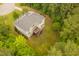 Beautiful aerial shot of the back of the home featuring a wooden deck overlooking a large green yard surrounded by dense trees at 119 Eagles Watch Ln, Chapel Hill, NC 27517