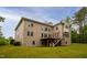 View of the back of the home featuring a wooden deck, and a staircase descending into a large manicured lawn at 119 Eagles Watch Ln, Chapel Hill, NC 27517