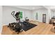 Basement gym features wood floors, workout equipment, window, and door to exterior at 119 Eagles Watch Ln, Chapel Hill, NC 27517