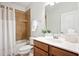 Bathroom featuring tub with tile surround, white vanity and mirror at 119 Eagles Watch Ln, Chapel Hill, NC 27517