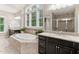 Spacious bathroom featuring a soaking tub, dual vanities with granite counters, and a tiled shower with glass door at 119 Eagles Watch Ln, Chapel Hill, NC 27517