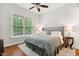 Cozy bedroom features a ceiling fan and large window with privacy blinds at 119 Eagles Watch Ln, Chapel Hill, NC 27517
