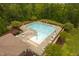 Aerial view of community pool with lounge chairs and tables for relaxing by the pool at 119 Eagles Watch Ln, Chapel Hill, NC 27517