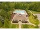 Aerial shot of community pool and clubhouse surrounded by lush greenery at 119 Eagles Watch Ln, Chapel Hill, NC 27517