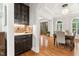 Transitional dining area with chandelier, brown wood floors, and an arched window with white shutters at 119 Eagles Watch Ln, Chapel Hill, NC 27517