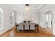 Formal dining room features a chandelier, hardwood floors, and wainscoting at 119 Eagles Watch Ln, Chapel Hill, NC 27517