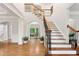 Grand foyer features hardwood floors, an elegant staircase, and arched doorways at 119 Eagles Watch Ln, Chapel Hill, NC 27517