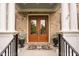 Elegant double front doors are framed by white pillars, enhancing curb appeal at 119 Eagles Watch Ln, Chapel Hill, NC 27517