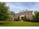 Stately brick home boasts dormer windows, manicured landscaping, and a welcoming entrance at 119 Eagles Watch Ln, Chapel Hill, NC 27517