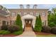 Stately brick home with a landscaped front yard, columns, and a brick walkway at 119 Eagles Watch Ln, Chapel Hill, NC 27517