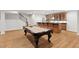Spacious game room with a pool table and adjacent bar with granite countertop at 119 Eagles Watch Ln, Chapel Hill, NC 27517