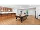 Basement game room with a pool table, bar area, and exercise equipment at 119 Eagles Watch Ln, Chapel Hill, NC 27517