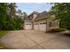Spacious three-car garage with a wide driveway, offering ample parking and storage with manicured landscaping at 119 Eagles Watch Ln, Chapel Hill, NC 27517