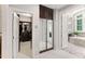 Hallway featuring a mirrored closet, leading to the walk-in closet and bathroom at 119 Eagles Watch Ln, Chapel Hill, NC 27517