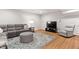 Cozy living room features a gray couch, gray recliner, patterned ottoman and rug at 119 Eagles Watch Ln, Chapel Hill, NC 27517