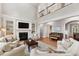 Inviting living room with a fireplace, built-ins, and a view of the upper level at 119 Eagles Watch Ln, Chapel Hill, NC 27517