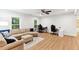 Open living room featuring a ceiling fan, L-shaped sofa, and two computer desks at 119 Eagles Watch Ln, Chapel Hill, NC 27517