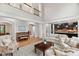 Open-concept space with a piano, fireplace, and seamless flow to the kitchen at 119 Eagles Watch Ln, Chapel Hill, NC 27517