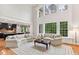 Bright living room featuring a soaring ceiling, large windows, and an open floor plan at 119 Eagles Watch Ln, Chapel Hill, NC 27517