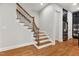 Elegant staircase features hardwood treads, white risers, and decorative black iron balusters at 119 Eagles Watch Ln, Chapel Hill, NC 27517