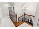 View of a beautiful staircase with a chandelier above, leading to the main level at 119 Eagles Watch Ln, Chapel Hill, NC 27517