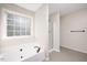 Clean bathroom showcasing a large tub under a window and a separate glass shower at 121 River Hills Dr, Clayton, NC 27527