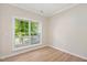 Light and airy bedroom featuring stylish flooring and window overlooking greenery at 121 River Hills Dr, Clayton, NC 27527