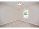 Simple bedroom with a window, neutral carpet, and freshly painted walls at 121 River Hills Dr, Clayton, NC 27527