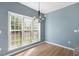 Dining area featuring a modern chandelier and large windows offering natural light at 121 River Hills Dr, Clayton, NC 27527