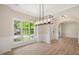 Elegant dining room featuring stylish flooring, modern light fixture, and large window at 121 River Hills Dr, Clayton, NC 27527