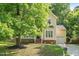 Charming two-story home with manicured lawn and lush, mature tree in front yard at 121 River Hills Dr, Clayton, NC 27527