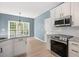 Well-equipped kitchen featuring stainless steel appliances, granite countertops, and large windows at 121 River Hills Dr, Clayton, NC 27527