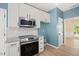 Modern kitchen with white cabinetry, stainless steel appliances, and granite countertops at 121 River Hills Dr, Clayton, NC 27527