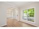 Bright living room featuring stylish flooring, archway, and large windows with greenery view at 121 River Hills Dr, Clayton, NC 27527