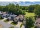 Aerial view of a home situated in a neighborhood with lush green trees and golf course views at 121 Walter Hagen Dr, Mebane, NC 27302