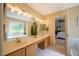 Bright Primary bathroom boasts a double vanity, large mirror, soaking tub, and shower at 121 Walter Hagen Dr, Mebane, NC 27302